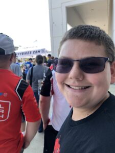 Photo of a 14 year old white male wearing glasses and smiling at the camera