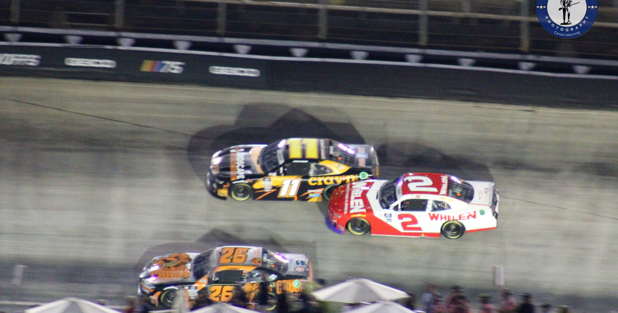 Kaz Grala running the low line at the 2023 Xfinity Bristol Night race with Sheldon Creed to his outside and Derek Kraus on the outside of Creed