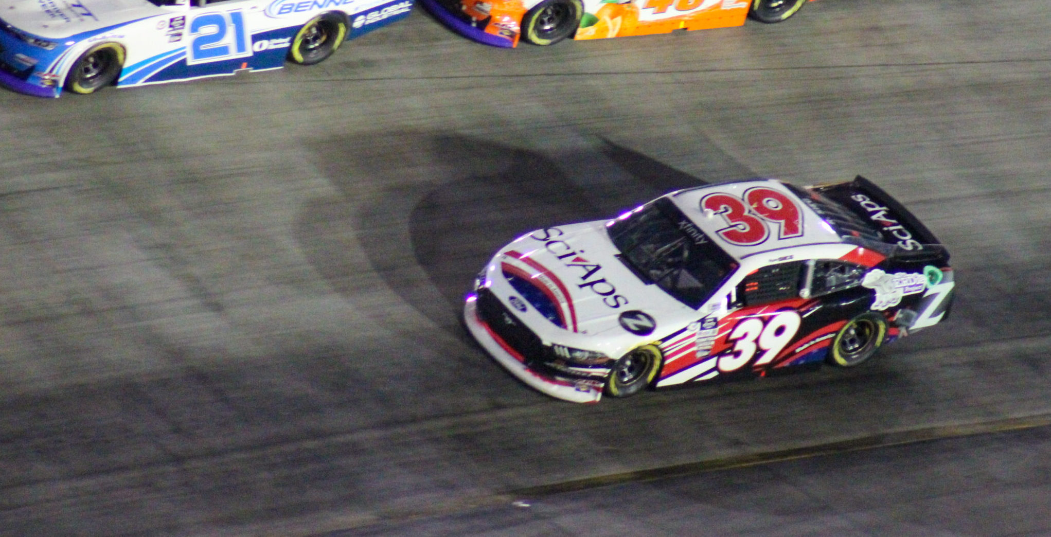 Austin Hill and Parker Kligerman above Ryan Sieg racing at the 2023 Xfinity Bristol Night Race