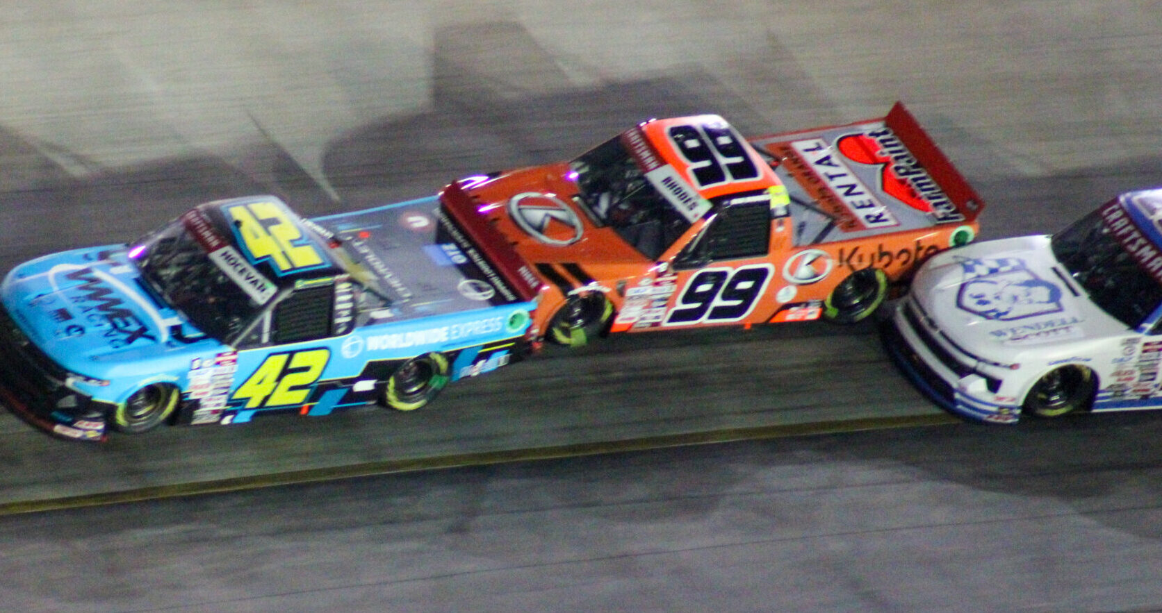 Ben Rhodes running behind Carson Hocevar and just in front of Rajah Caruth during the 2023 Bristol Truck Night Race
